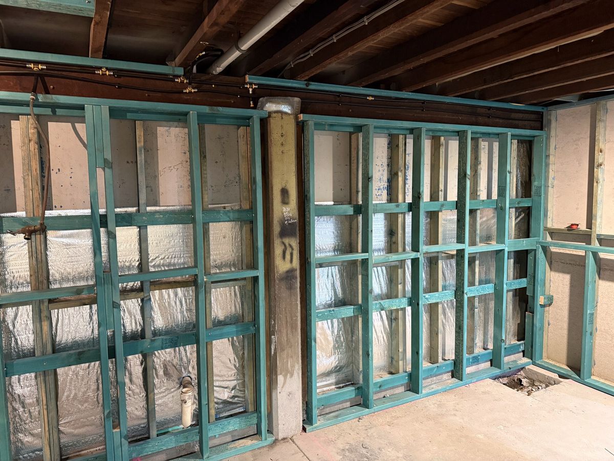 Wall framing and bracing to an existing structure