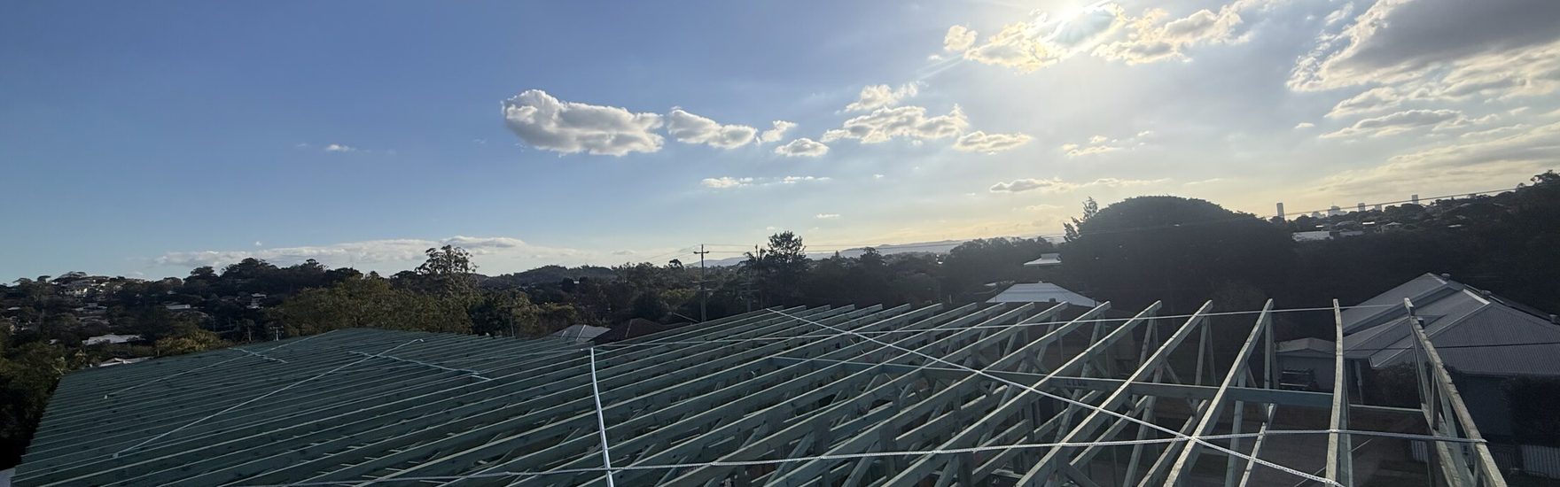 Roof trusses set and braced against a clear sky